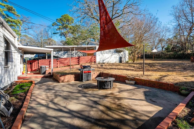 view of patio featuring a storage unit and a grill