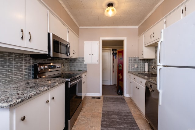 kitchen with sink, white cabinetry, stainless steel appliances, and stone counters