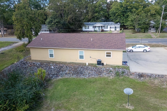 view of side of home with a lawn