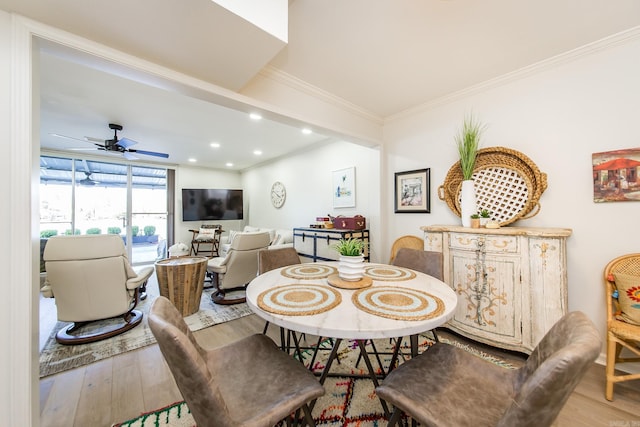 dining area featuring hardwood / wood-style flooring, ceiling fan, and ornamental molding