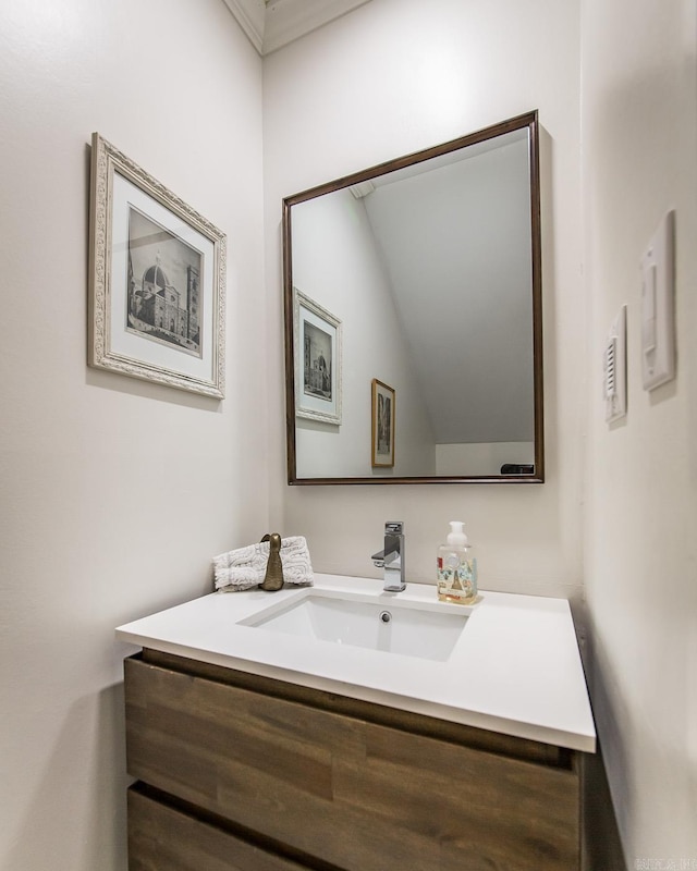 bathroom with vanity and ornamental molding