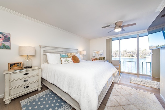 bedroom featuring ceiling fan, dark hardwood / wood-style floors, crown molding, and access to outside