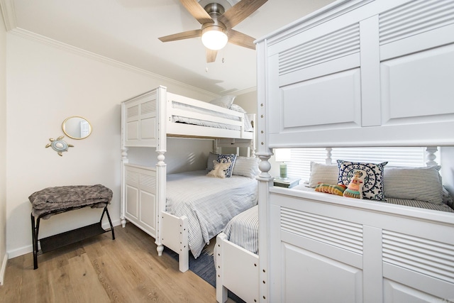 bedroom with light hardwood / wood-style flooring, ceiling fan, and ornamental molding