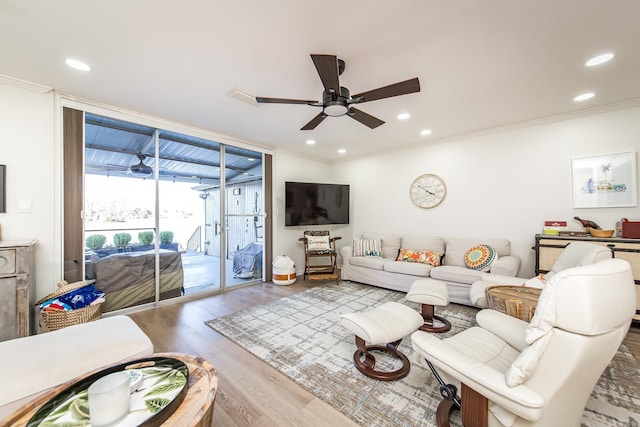 living room with light hardwood / wood-style floors, ceiling fan, and crown molding