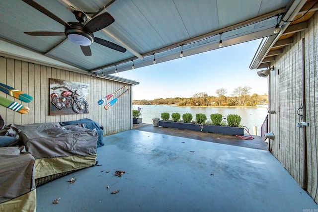 view of patio / terrace featuring a water view and ceiling fan