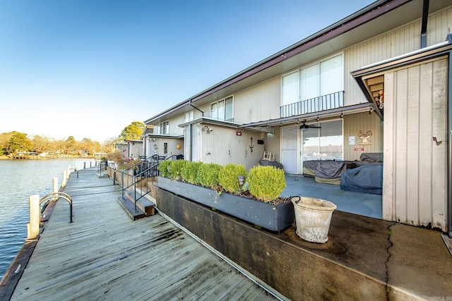 view of dock featuring a water view and a patio area