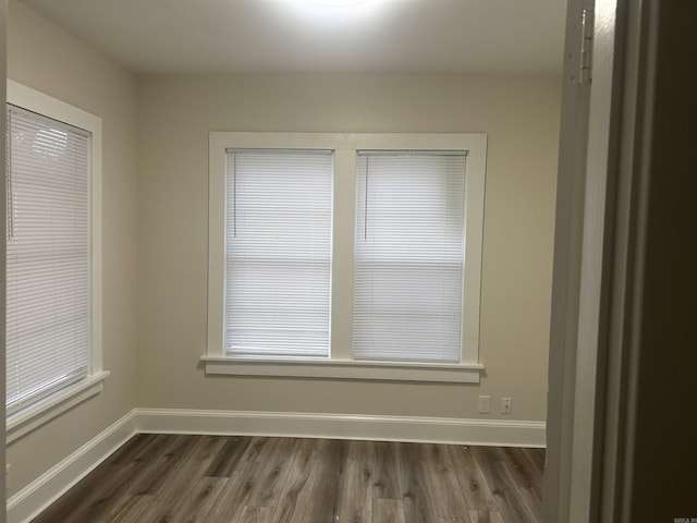 unfurnished room featuring dark wood-type flooring