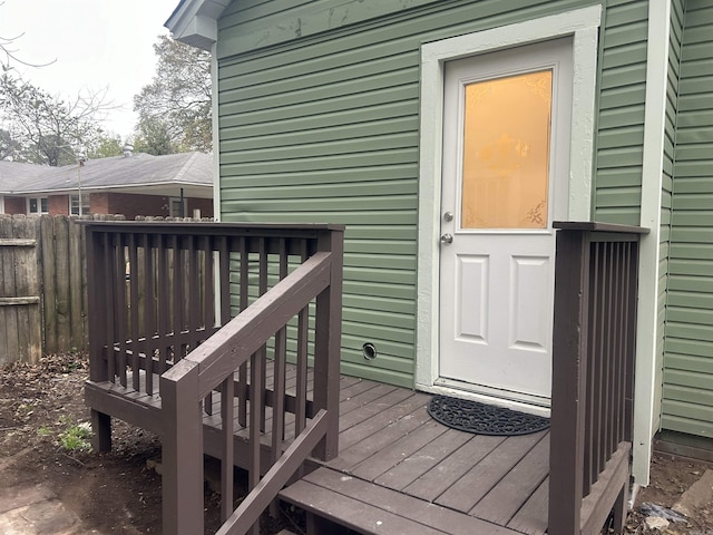 view of exterior entry featuring a deck