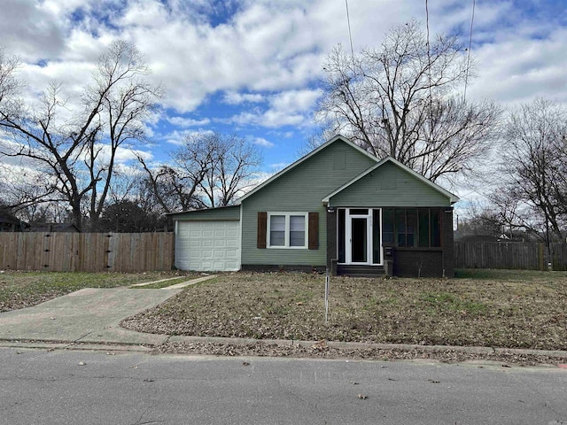 view of front of home with a sunroom and a garage