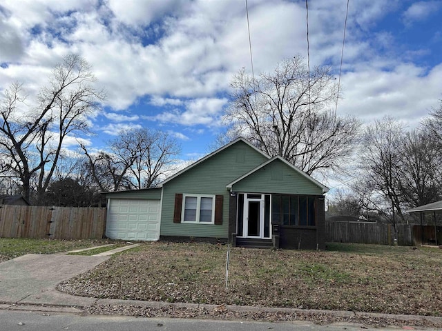 view of front of property with a garage and a sunroom