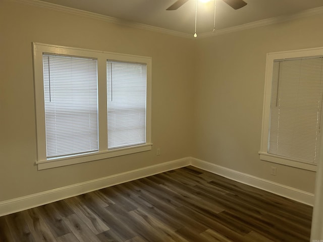 empty room featuring crown molding, ceiling fan, and dark wood-type flooring