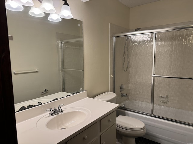 full bathroom with shower / bath combination with glass door, vanity, and toilet