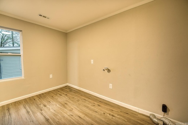 unfurnished room featuring light hardwood / wood-style floors and crown molding