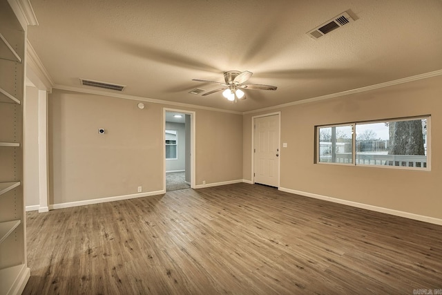 spare room with ceiling fan, crown molding, a textured ceiling, and hardwood / wood-style flooring