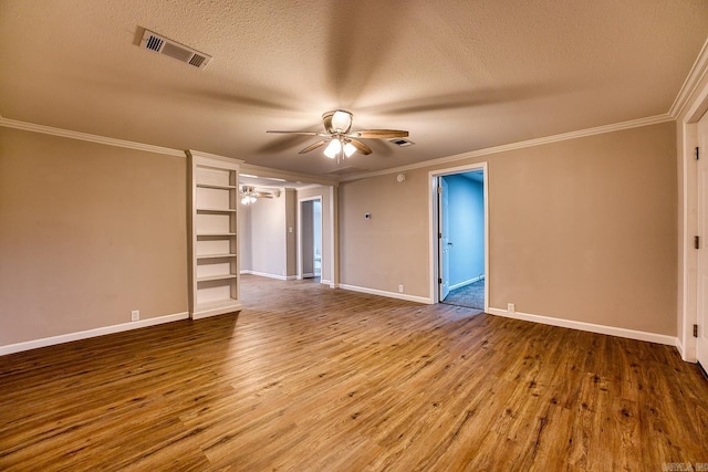 unfurnished room featuring a textured ceiling, ceiling fan, wood-type flooring, and ornamental molding