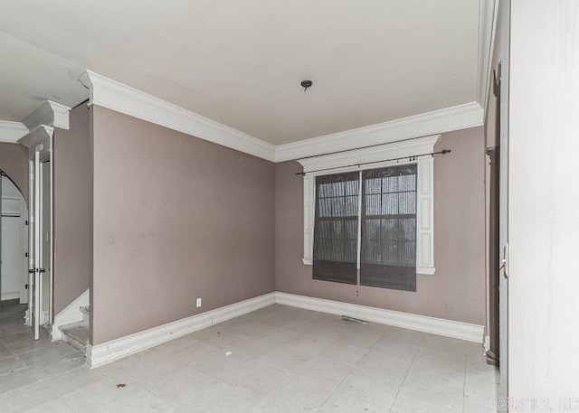 empty room featuring crown molding