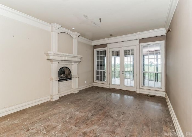 unfurnished living room with french doors, dark hardwood / wood-style flooring, and crown molding