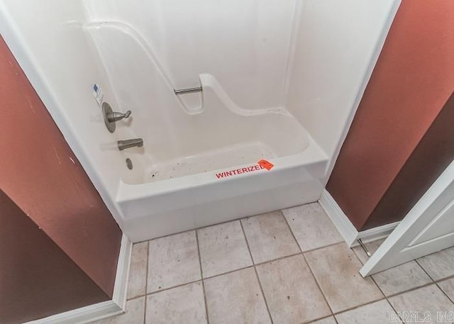 bathroom with tile patterned flooring and shower / bathtub combination