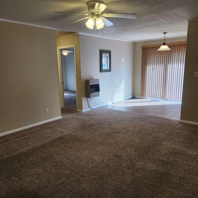 carpeted spare room featuring heating unit, ceiling fan, and a textured ceiling