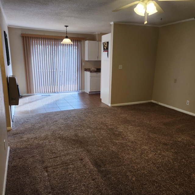 carpeted empty room with heating unit, ceiling fan, and ornamental molding