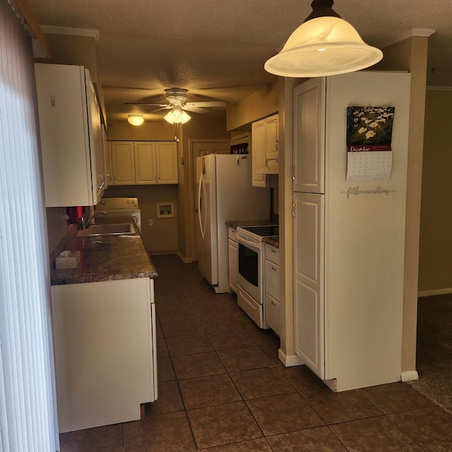 kitchen featuring white appliances, sink, ceiling fan, decorative light fixtures, and white cabinetry