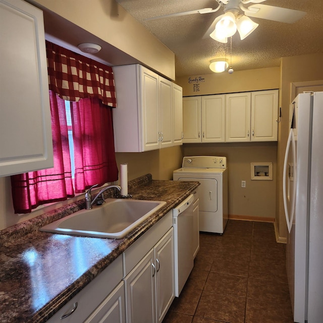 washroom featuring ceiling fan, sink, cabinets, a textured ceiling, and washer / dryer