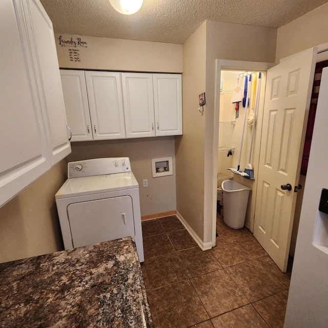 clothes washing area with cabinets, washer / dryer, and a textured ceiling