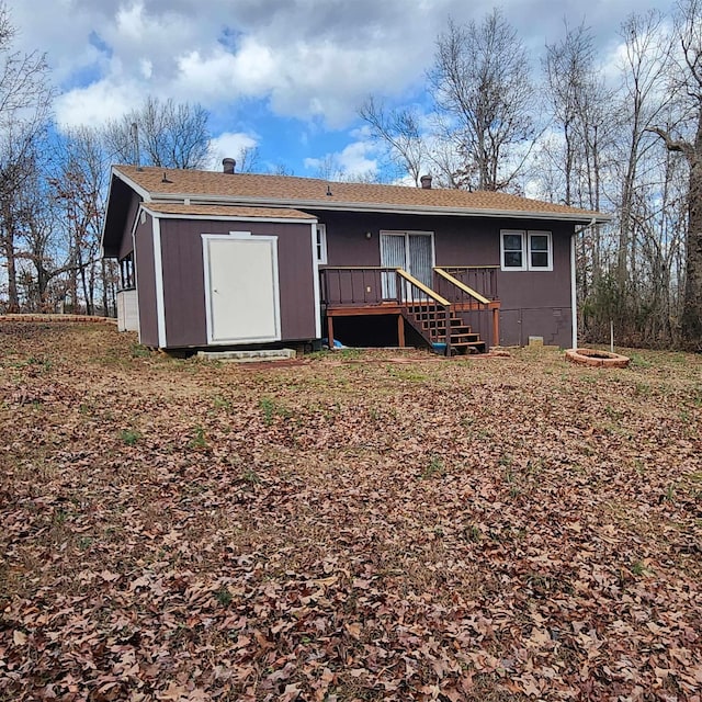 back of house with a deck