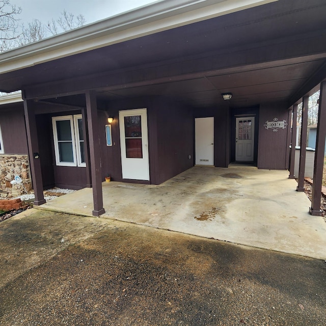 entrance to property featuring a carport