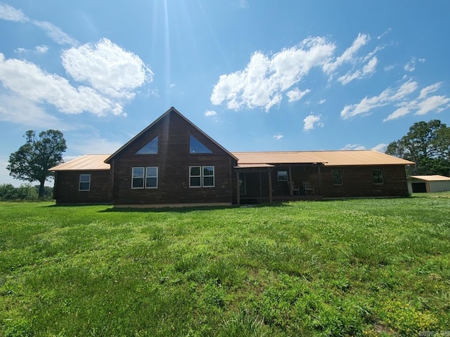 back of property featuring a yard