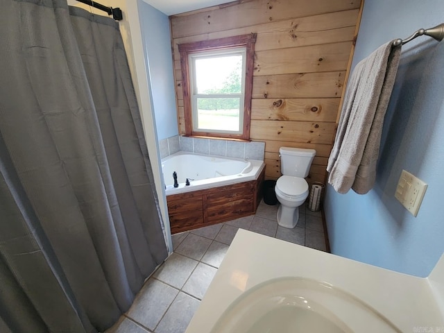 full bathroom with wood walls, plus walk in shower, tile patterned floors, sink, and toilet