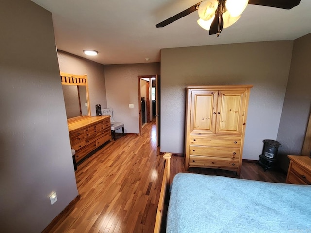 bedroom with light hardwood / wood-style floors and ceiling fan