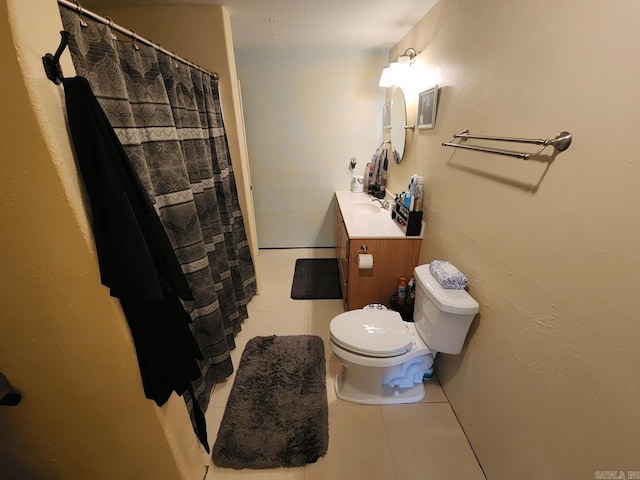 bathroom featuring tile patterned flooring, vanity, curtained shower, and toilet