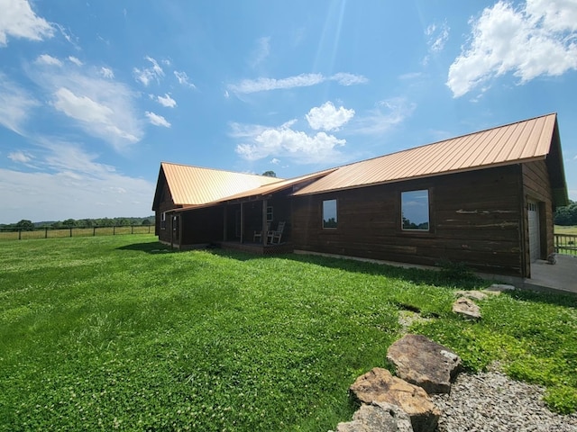 view of side of property featuring a garage and a yard