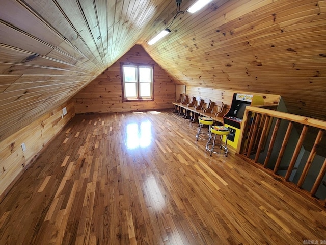 bonus room with wooden walls, wooden ceiling, lofted ceiling, and wood-type flooring