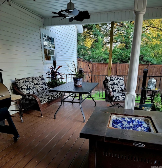 wooden terrace featuring a fire pit and ceiling fan