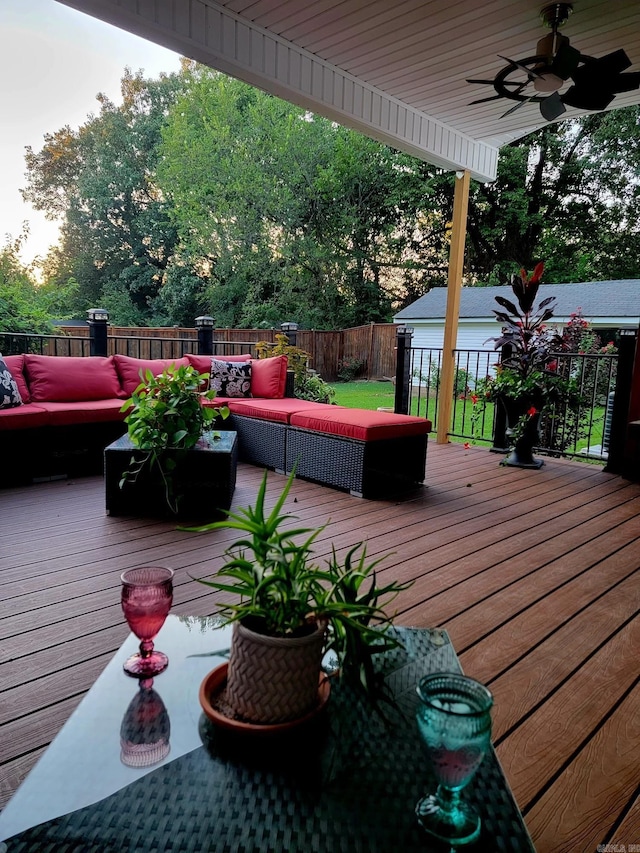 wooden deck featuring ceiling fan and an outdoor living space