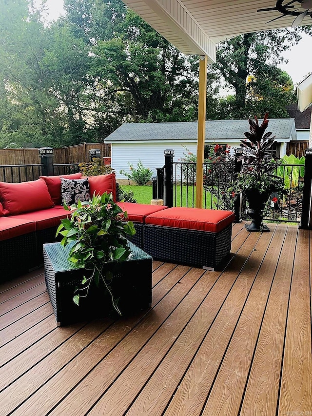 wooden terrace featuring an outdoor hangout area and ceiling fan