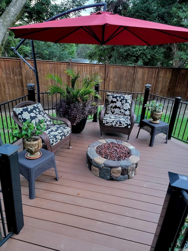 wooden deck with an outdoor fire pit