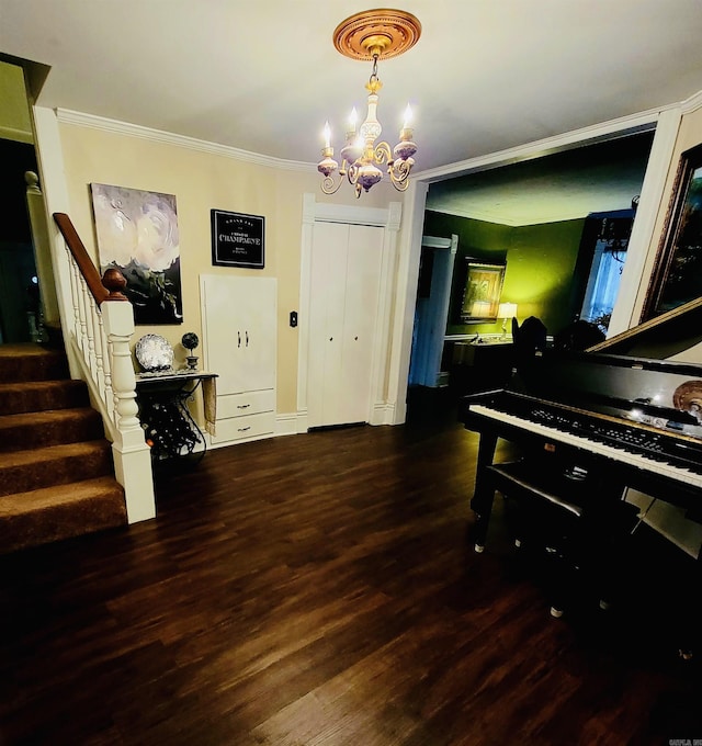 interior space with a chandelier, dark hardwood / wood-style flooring, and ornamental molding