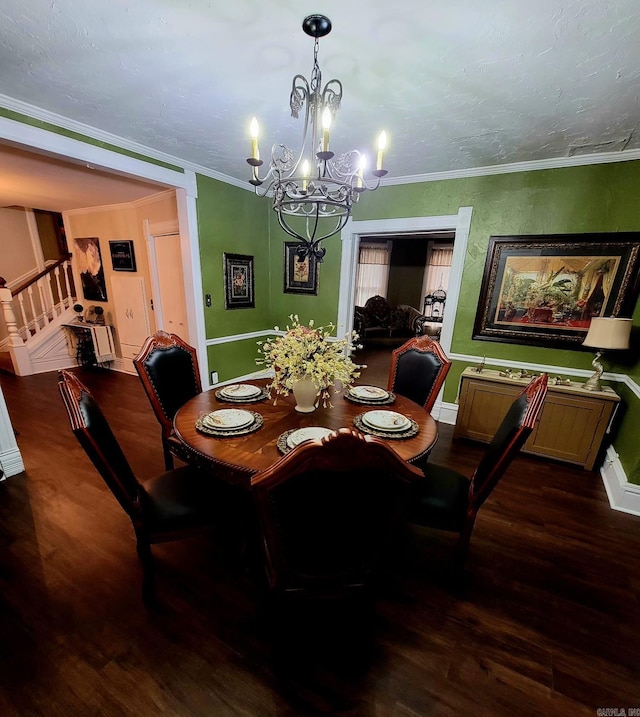 dining space with ornamental molding, dark wood-type flooring, and an inviting chandelier