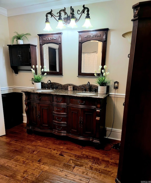 bathroom featuring hardwood / wood-style flooring, vanity, and ornamental molding