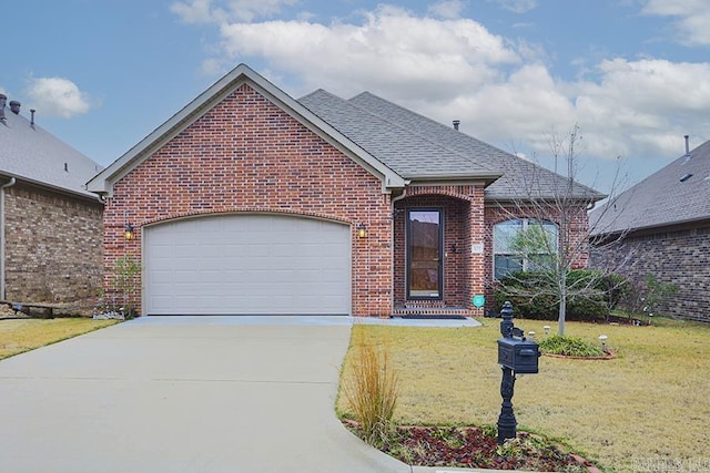 view of front facade with a front yard and a garage