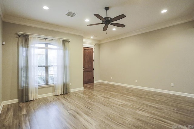 spare room with ceiling fan, crown molding, and light hardwood / wood-style flooring