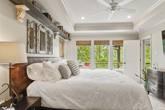 bedroom with ceiling fan, a raised ceiling, and crown molding