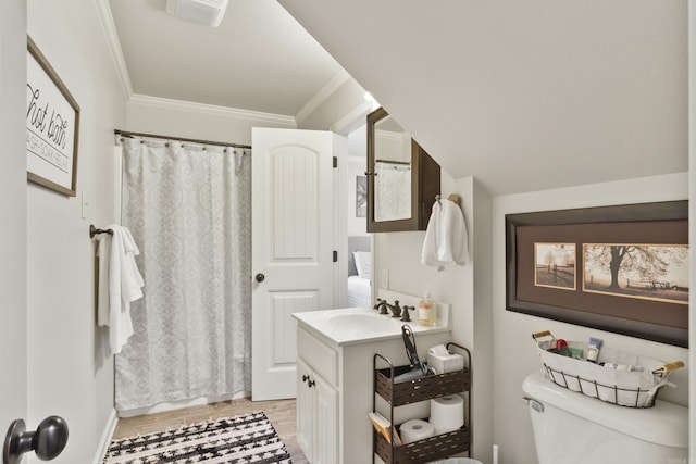 bathroom featuring vanity, toilet, crown molding, and walk in shower