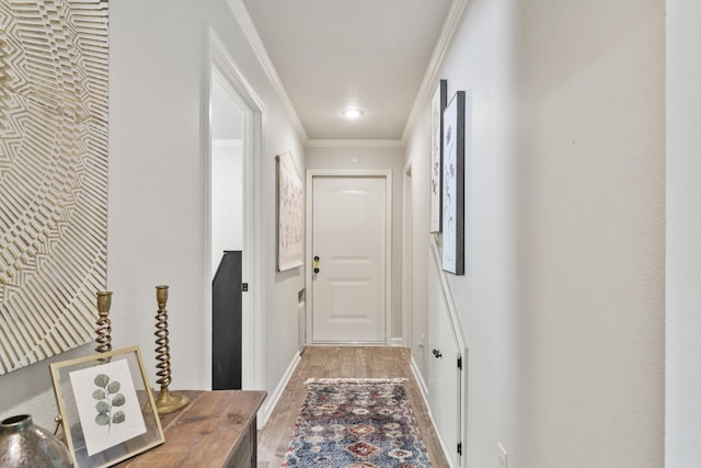 corridor with hardwood / wood-style flooring and crown molding