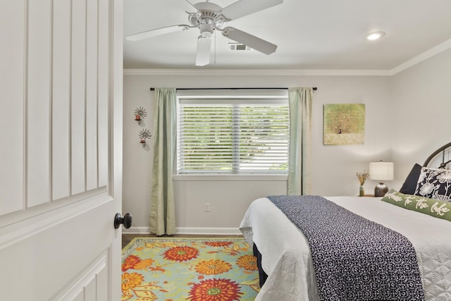 bedroom with ceiling fan and crown molding