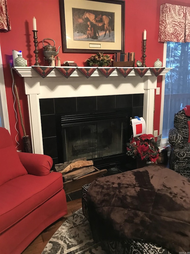 room details with a tile fireplace and hardwood / wood-style floors