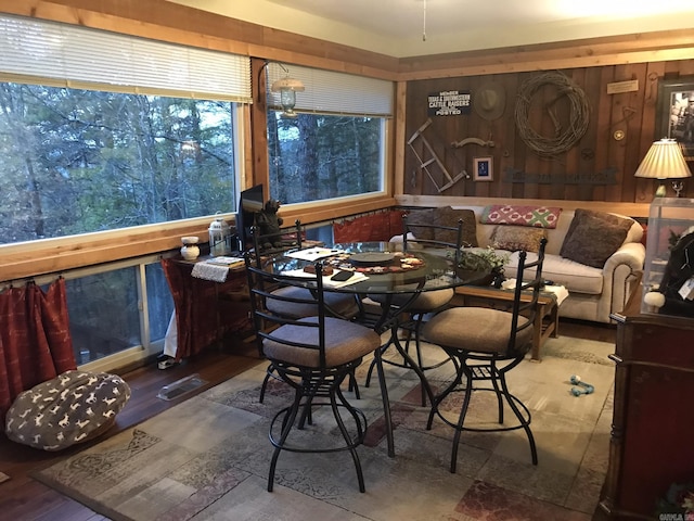 dining space featuring wooden walls